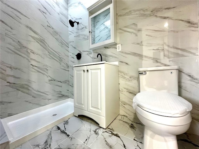 full bathroom featuring a shower stall, marble tiled flooring, toilet, and vanity