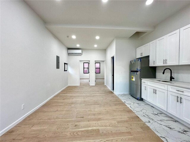 bathroom with tiled shower, vanity, and a skylight