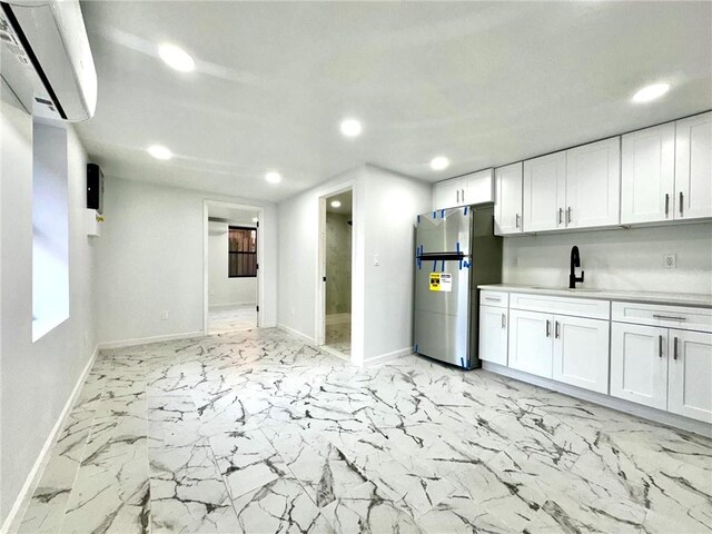 kitchen with stainless steel refrigerator, sink, black electric range, and white cabinets