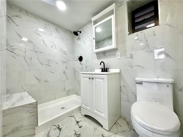 bathroom featuring marble finish floors, a shower stall, toilet, and vanity