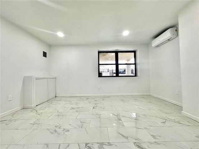 empty room with marble finish floor, an AC wall unit, recessed lighting, and baseboards