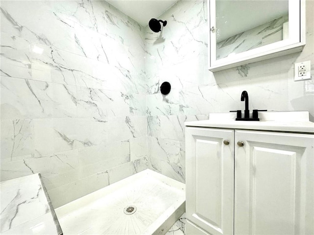 full bath featuring backsplash, a shower stall, and vanity