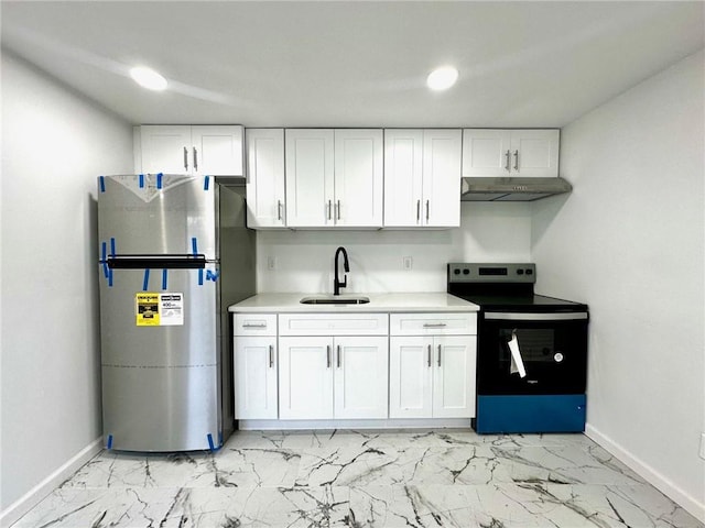 kitchen with marble finish floor, appliances with stainless steel finishes, white cabinetry, a sink, and under cabinet range hood