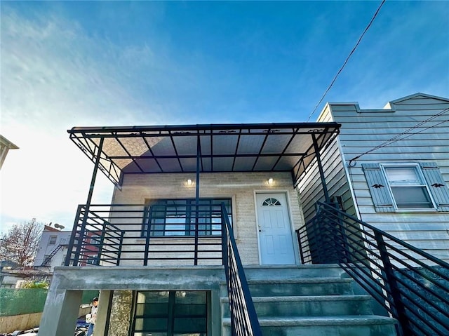 entrance to property featuring a balcony