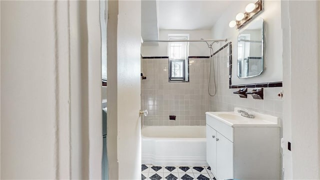 bathroom featuring vanity, tile walls, tub / shower combination, and tile patterned floors