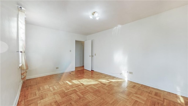 unfurnished room featuring baseboards