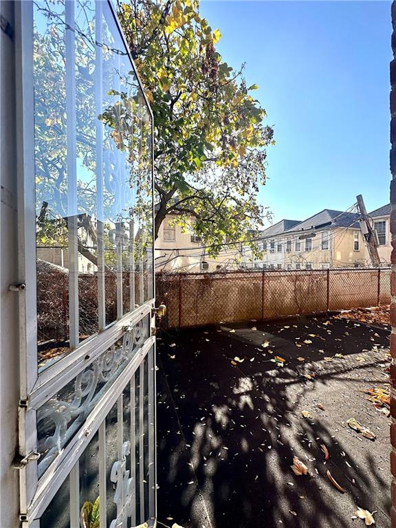 view of yard featuring fence and a residential view