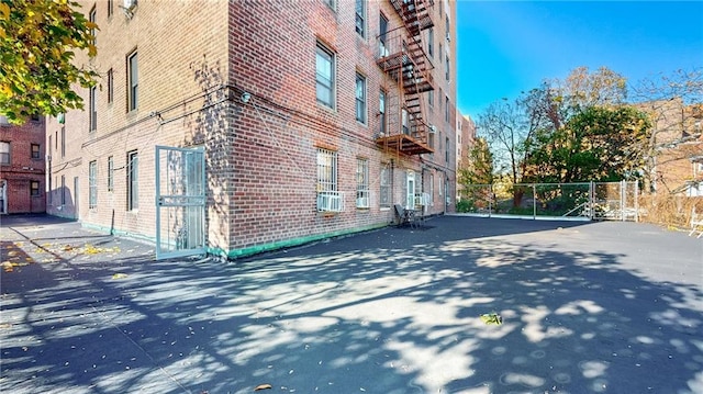 exterior space featuring cooling unit and brick siding