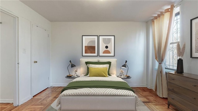 bedroom with baseboards and multiple windows