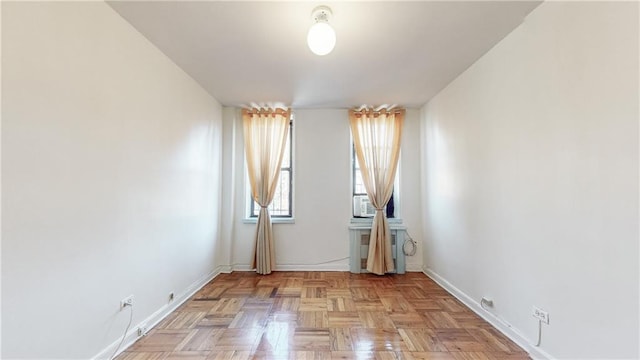 spare room with baseboards