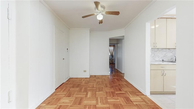 hall featuring crown molding and baseboards