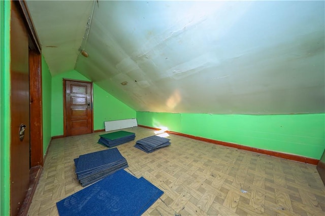 interior space featuring lofted ceiling and baseboards