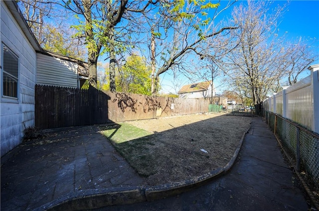 view of yard featuring a fenced backyard and a patio