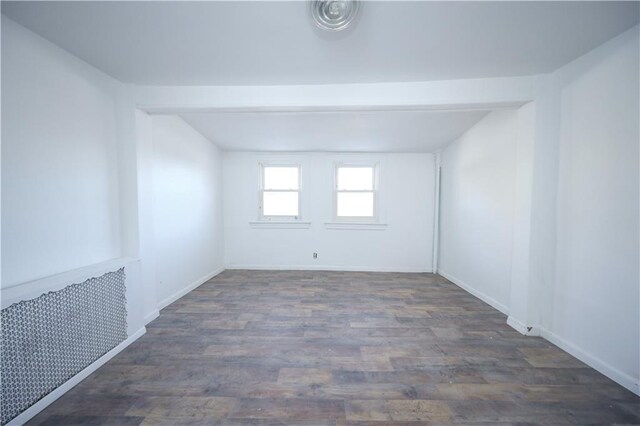 empty room with dark hardwood / wood-style flooring