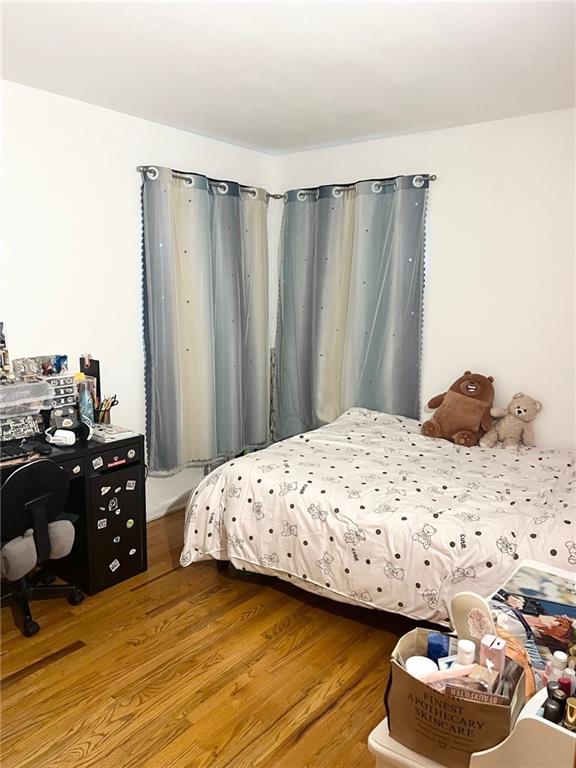 bedroom with wood-type flooring