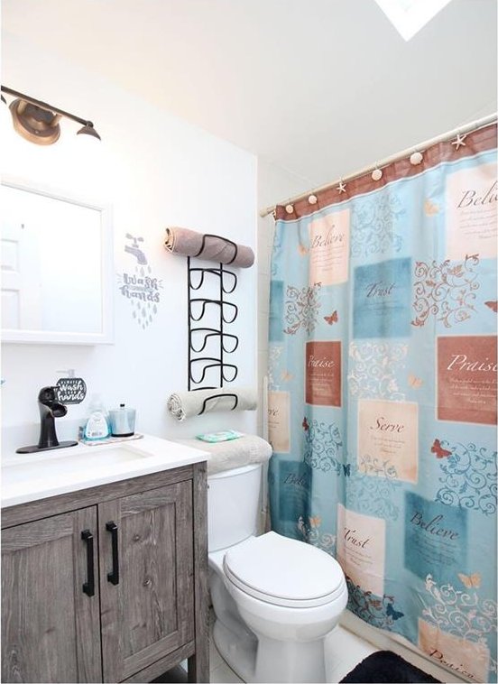 bathroom with tile patterned flooring, a shower with curtain, vanity, and toilet