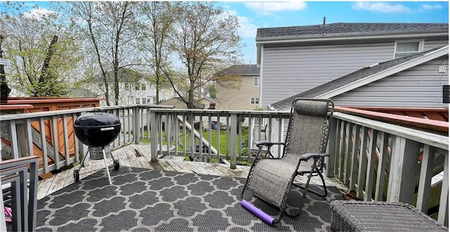 wooden balcony featuring area for grilling and a wooden deck