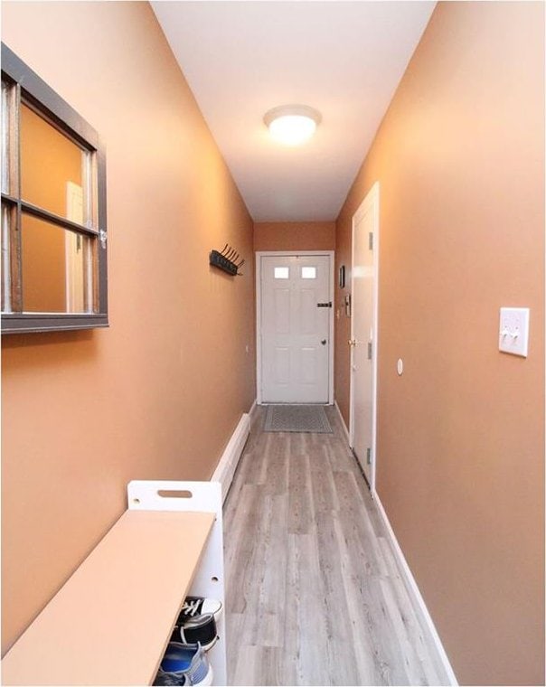 hallway with light hardwood / wood-style flooring