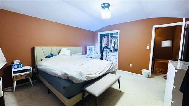 carpeted bedroom featuring a closet and lofted ceiling