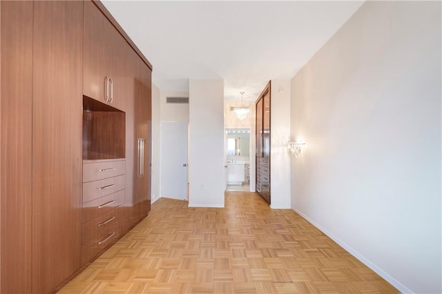 40 Oceana Dr W Unit 5G, Brooklyn, NY 11235 - corridor featuring baseboards and a chandelier