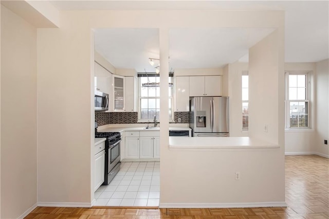 40 Oceana Dr W Unit 5G, Brooklyn, NY 11235 - kitchen with appliances with stainless steel finishes, a sink, decorative backsplash, and baseboards