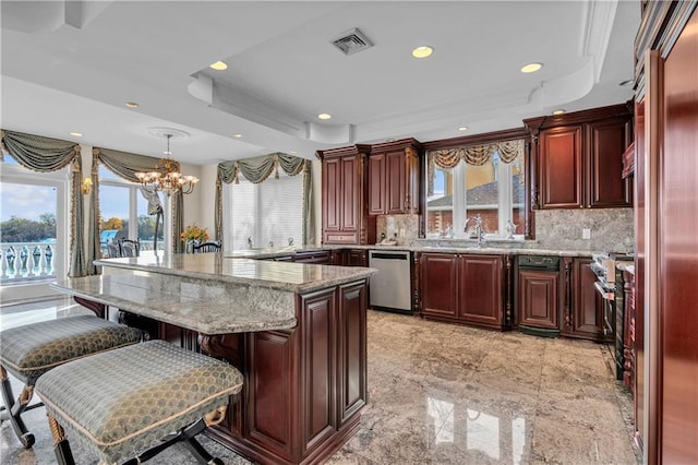 kitchen with backsplash, stainless steel appliances, pendant lighting, an inviting chandelier, and a center island