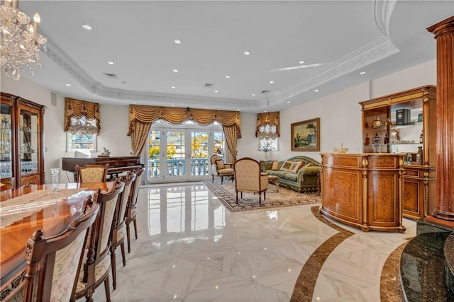 interior space featuring a raised ceiling, french doors, and a notable chandelier