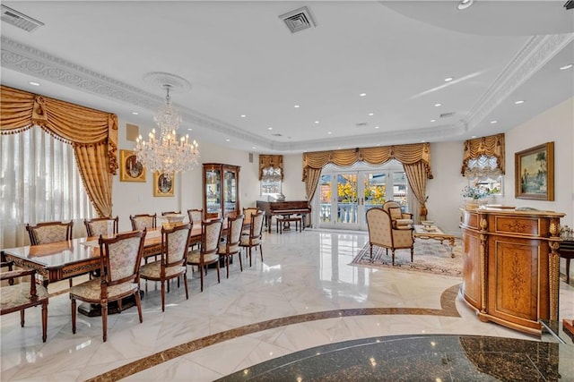 dining space with a tray ceiling, an inviting chandelier, and ornamental molding