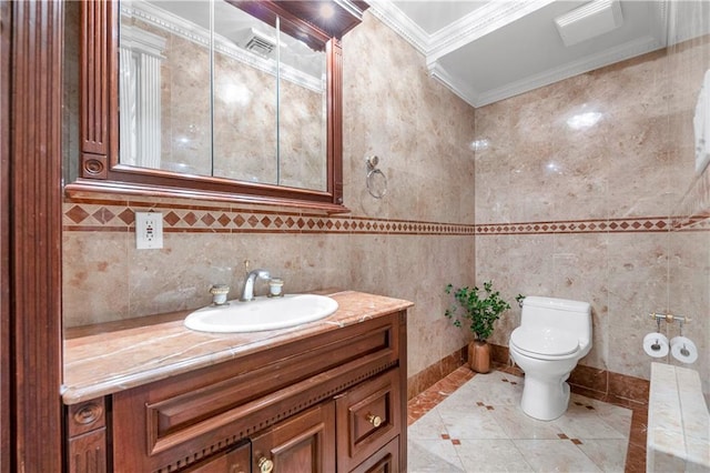 bathroom with crown molding, vanity, tile walls, and toilet