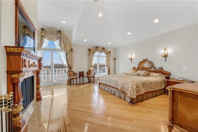 bedroom featuring access to outside and light hardwood / wood-style flooring