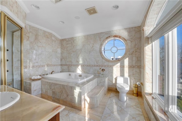 bathroom with a wealth of natural light and tile walls