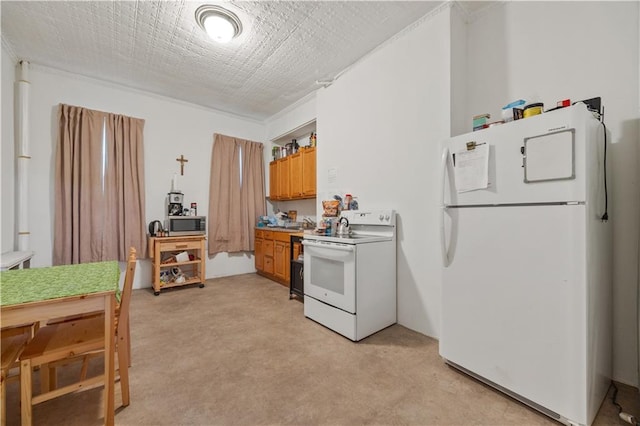 kitchen with light carpet, a textured ceiling, white appliances, and crown molding