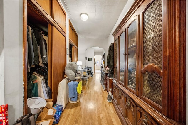 corridor with light hardwood / wood-style floors