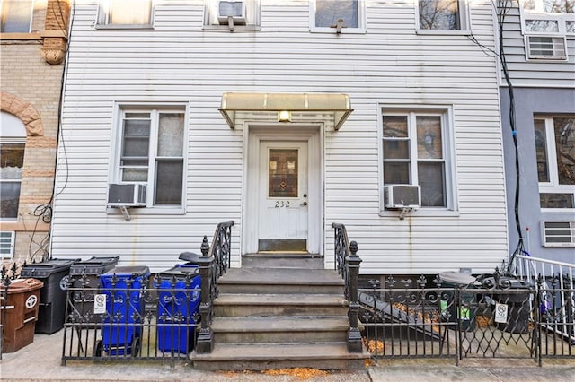 entrance to property featuring cooling unit