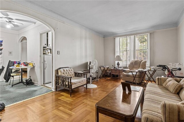 living room with ceiling fan and parquet flooring