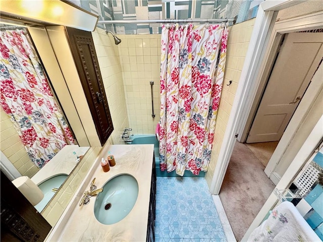 bathroom featuring vanity and shower / bathtub combination with curtain