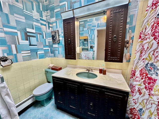 bathroom with baseboard heating, vanity, toilet, and tile walls