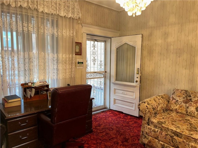 office space featuring dark colored carpet and an inviting chandelier