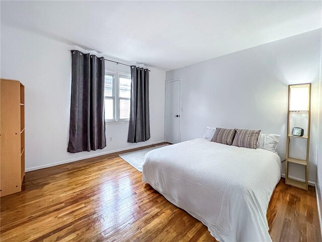 bedroom with wood-type flooring