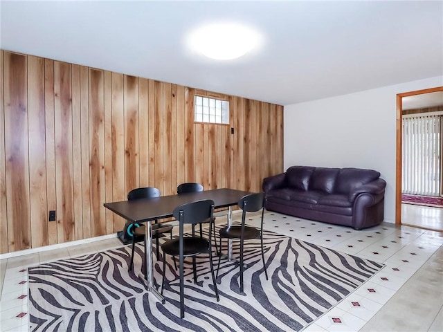 interior space featuring wood walls and light tile patterned floors