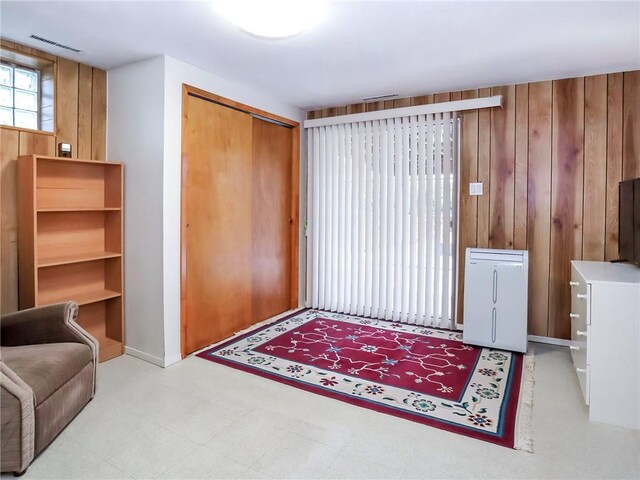 foyer with wood walls