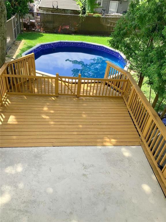 view of swimming pool with a wooden deck and a yard