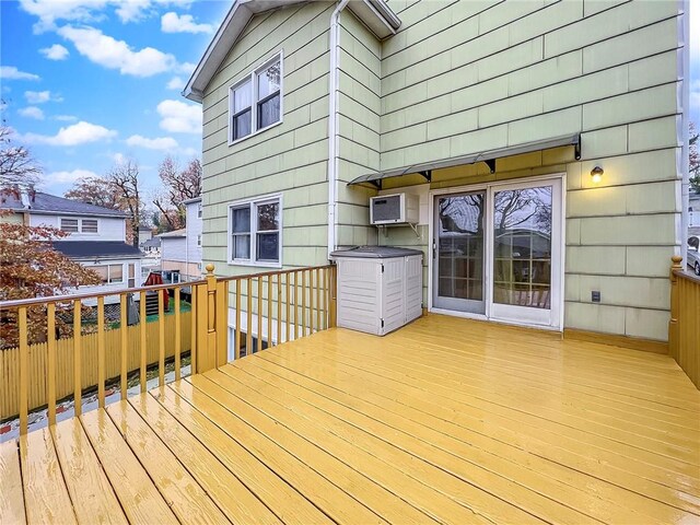 wooden deck featuring a wall mounted air conditioner