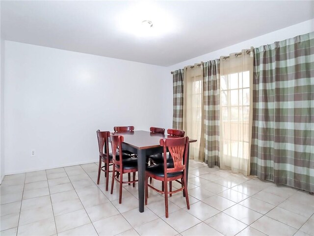 dining space featuring light tile patterned floors