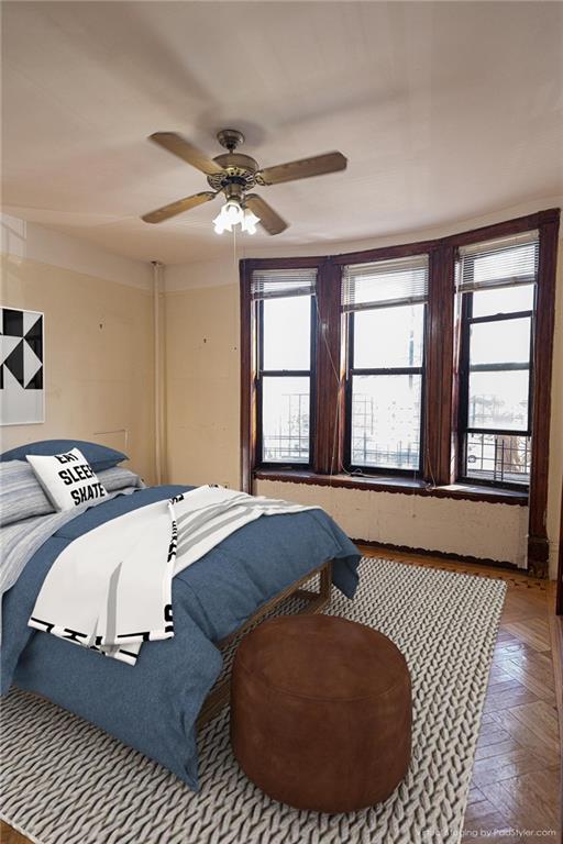 bedroom featuring ceiling fan and parquet floors