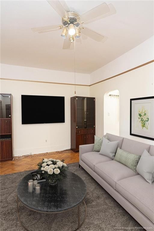 living room featuring ceiling fan and hardwood / wood-style floors