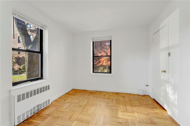 35 Oliver St Unit 1D, Brooklyn, NY 11209 - unfurnished room featuring radiator heating unit, plenty of natural light, and baseboards