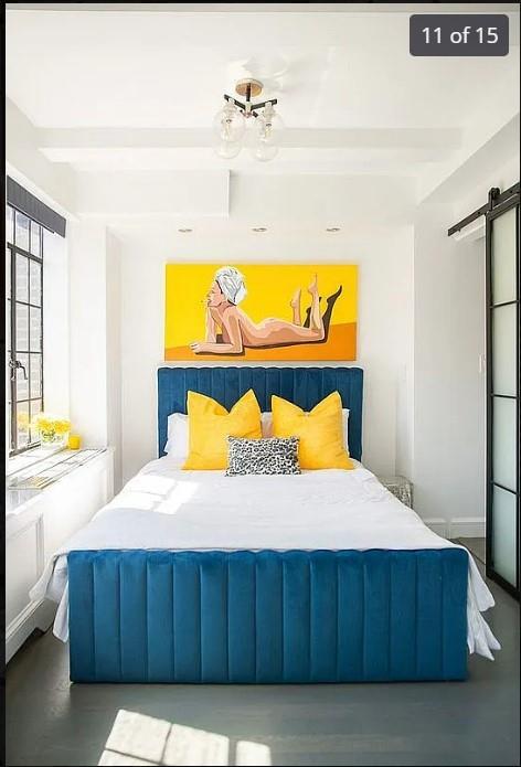 bedroom featuring beam ceiling and a barn door