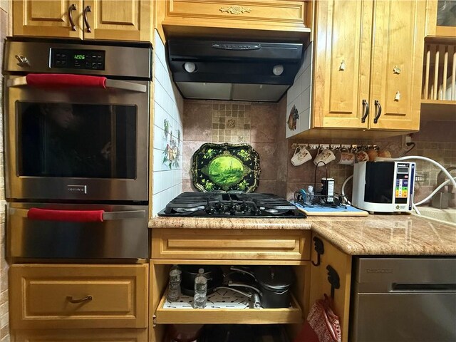 kitchen with stainless steel double oven, ventilation hood, black gas stovetop, and backsplash