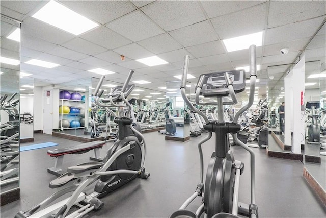 exercise room with a paneled ceiling